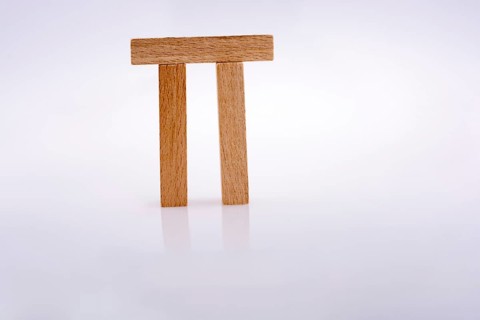 Wooden domino pieces positioned on white background