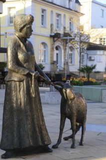 Statue of a woman with a goat on the main street