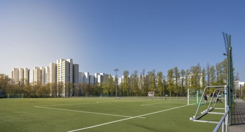 Football field and high-rise buildings in the Maerkisches Viertel residential area in Berlin Reinickendorf