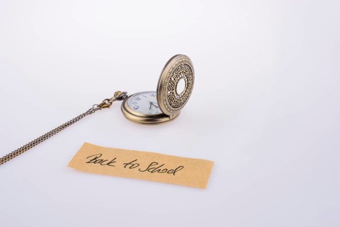 Back to school written title and a pocket watch