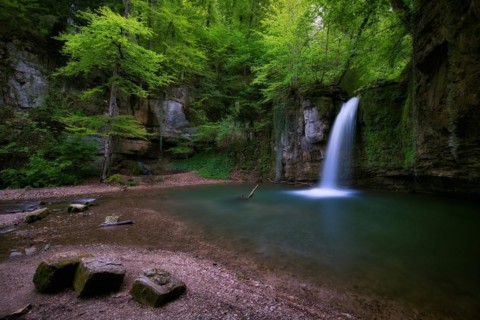 Waterfall in the forest with small pond near Kilchberg