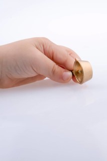 Child holding a tiny cooking pan in hand on a white background
