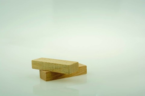 Wooden domino pieces positioned on white background