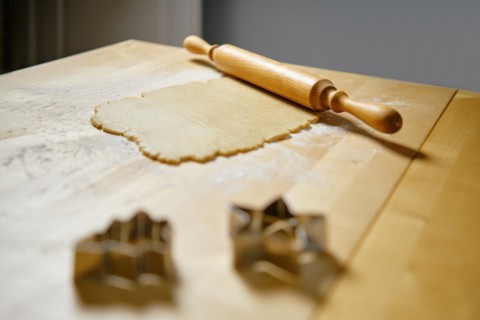 Flat ginger dough on the kitchen table and rolling pin