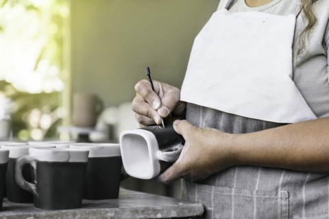 Clay workshop. The process of creating pottery. Master potter working in her studio