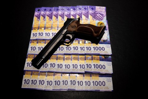 Elegant Semiautomatic 9mm Handgun with Swiss Helvetia Symbol Leaning on Swiss Franc 1000 Banknote in Switzerland