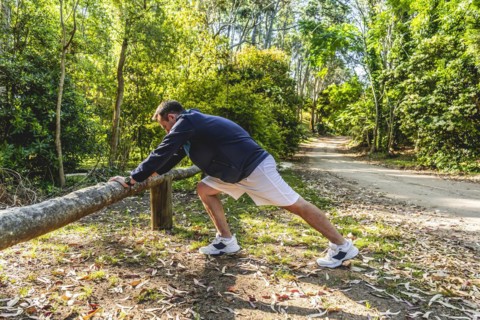 Man doing stretching exercises outdoors