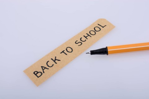 Pen and back to school title on a notebook