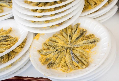 Set of plates with fried anchovies fish as seafood