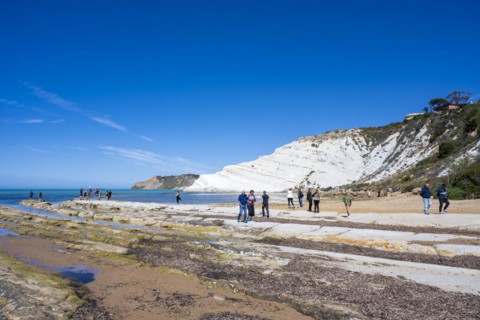 Tourists at the chalk cliff Scala dei Turchi