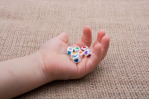Colorful cubes with a heart in hand on canvas