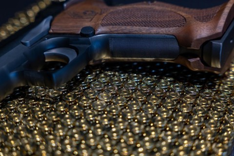 Elegant Semiautomatic 9mm Handgun with Swiss Helvetia Symbol Leaning on Bullet Ammunition in Switzerland