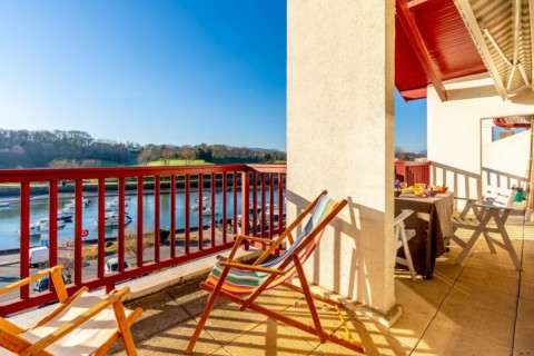 Summer house terrace. Beautiful terrace with wooden railing looking at the sea