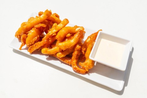 Fried battered squid with mayonnaise sauce. traditional mediterranean food
