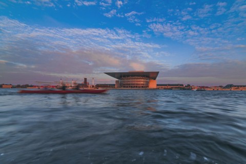 Water canal with opera house in background
