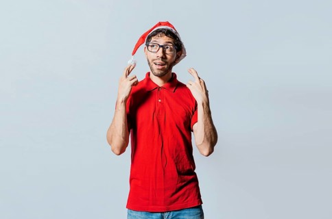 Hopeful man in christmas clothes making a wish