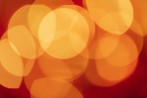 Red tone blurs the bokeh light. Defocused Red and orange holiday bokeh. Abstract christmas background