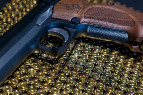 Elegant Semiautomatic 9mm Handgun with Swiss Helvetia Symbol Leaning on Bullet Ammunition in Switzerland