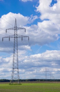 Distribution of electrical energy by means of overland power line consisting of overhead line pylons and overhead line