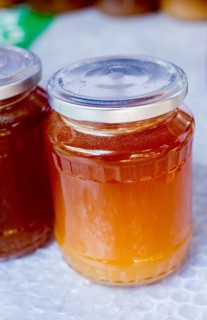 Glass jar of full of fresh honey with lid