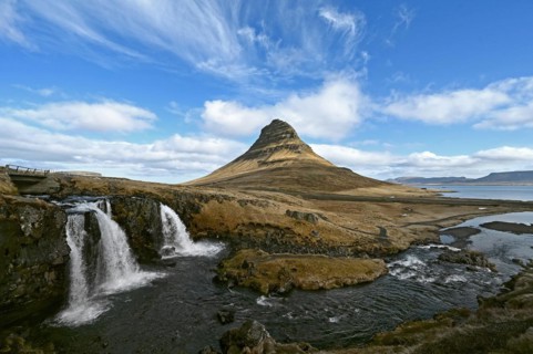 Kirkjufellsfoss waterfall and Kirkjufell mountain on the north coast of the Snaefellsnes peninsula in western Iceland