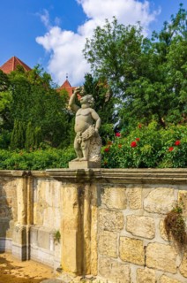 Stone sculpture of a putto in the Abbey and Palace Garden of Quedlinburg