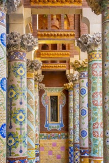 Columns with colourful mosaic on the outdoor terrace