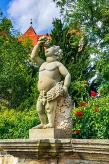 Stone sculpture of a putto in the Abbey and Palace Garden of Quedlinburg