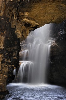 Waterfall created by the Smoo burn dropping into the Smoo cave through a sinkhole near Durness in the Highlands