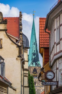 View through the narrow alley of Bockstrasse to one of the towers of the church St. Nikolai in the old town of the world heritage city