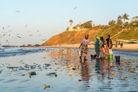 Fishermen's wives on the beach at the fish market