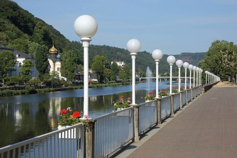 Lahn riverside promenade with row of street lamps and view of Russian church St. Andreas