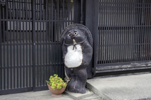 House front raccoon dog ornament at Narai-juku traditional small town in Nagano Japan