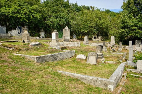 Overgrown and desolate burial ground at the dilapidated and abandoned cemetery in Horni Krupka