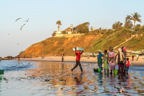 Fishermen's wives on the beach at the fish market