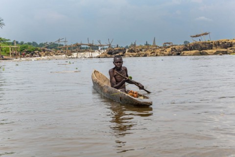 Fisherman in his dugout canoe