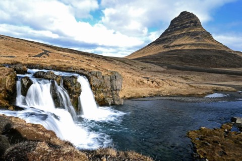 Kirkjufellsfoss waterfall and Kirkjufell mountain on the north coast of the Snaefellsnes peninsula in western Iceland