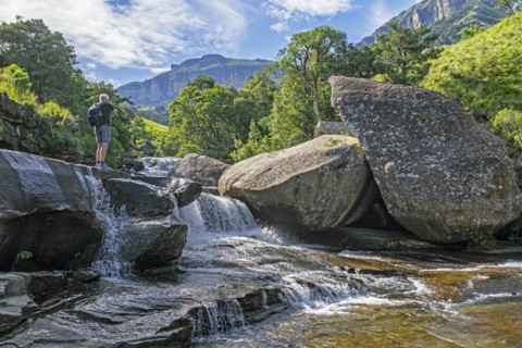 Western tourist visiting cascade in the Mahai River in the Royal Natal National Park