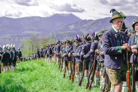 Mountain riflemen gather at the patron saint's day in a meadow near Gmund am Tegernsee