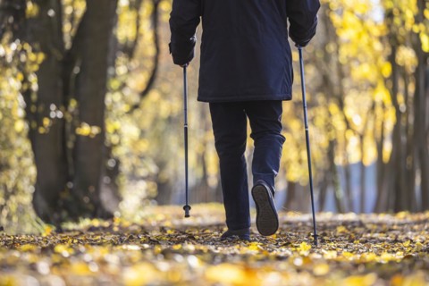 Old man with sticks taking a walk