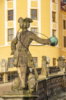 Baroque statue of a hunter with dog in front of the main entrance