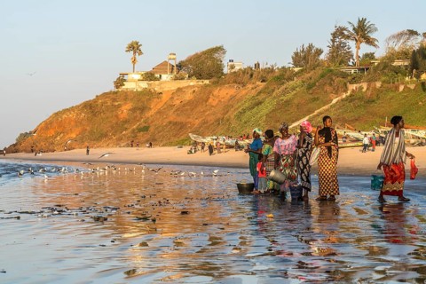 Fishermen's wives on the beach at the fish market