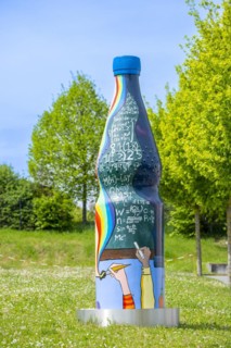 Oversized painted mineral water bottle in front of the European School RheinMain