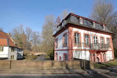 Building at Fuerstenau Castle with bridge over the Muemling stream