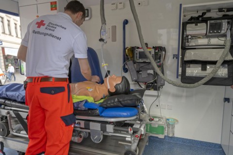 DRK staff in the ambulance Ambulance with dummy as demonstration