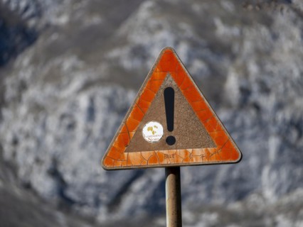 Weathered traffic sign with exclamation mark