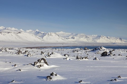 Lava field covered in snow at the Snaefellsjoekull National Park in winter on the Snaefellsnes peninsula in Iceland