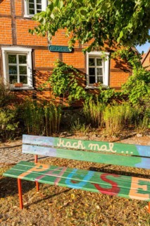 Bench with inscription Mach mal Pause