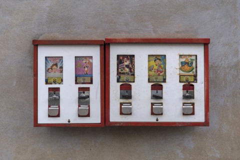 Chewing gum vending machines from the 1950s on a house wall