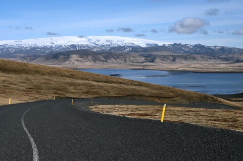 Road to the small peninsula of Dyrholaey on the south coast with a view of the glacier Myrdalsjoekull